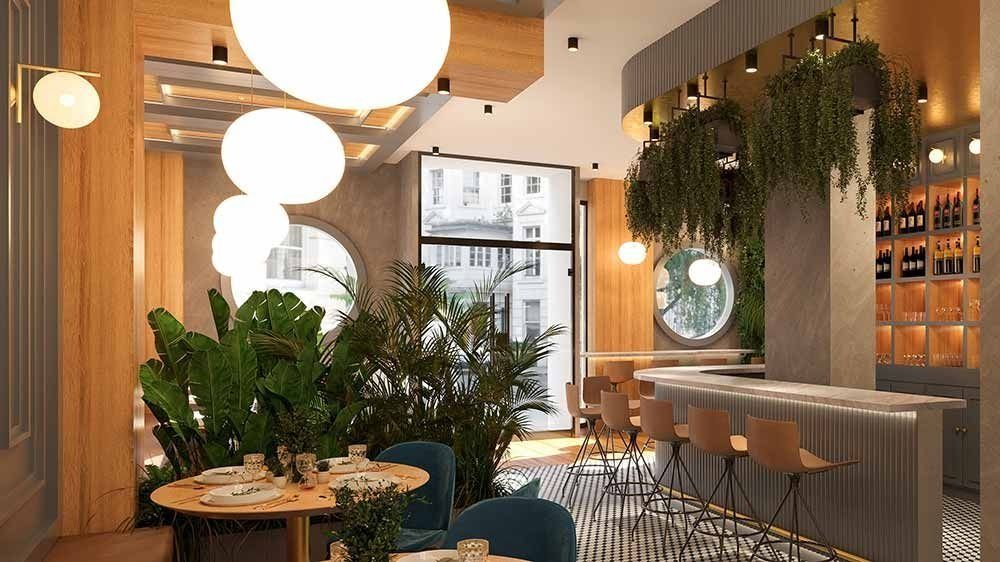 Interior de un restaurante moderno con barra, mesas, plantas y grandes lámparas de globo.