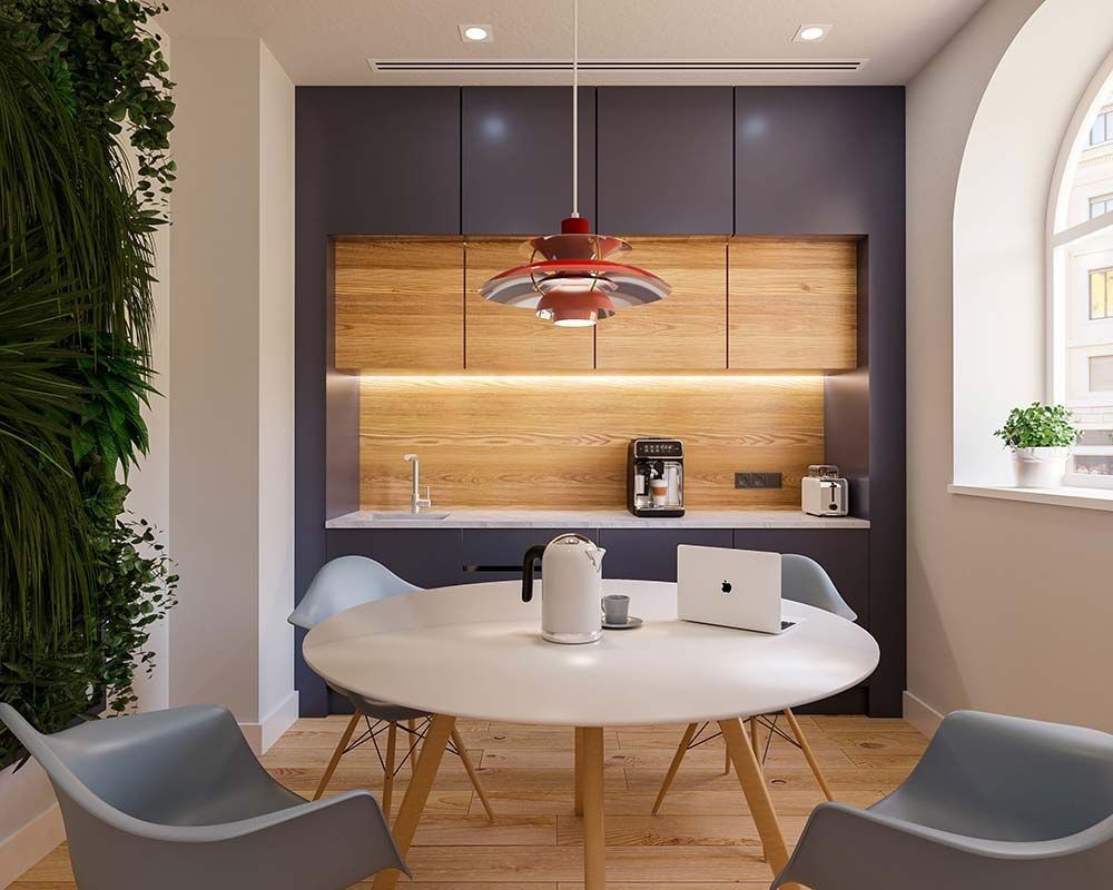 Cocina y comedor modernos con mesa redonda, sillas y gabinetes empotrados, con detalles de madera y una pared verde.