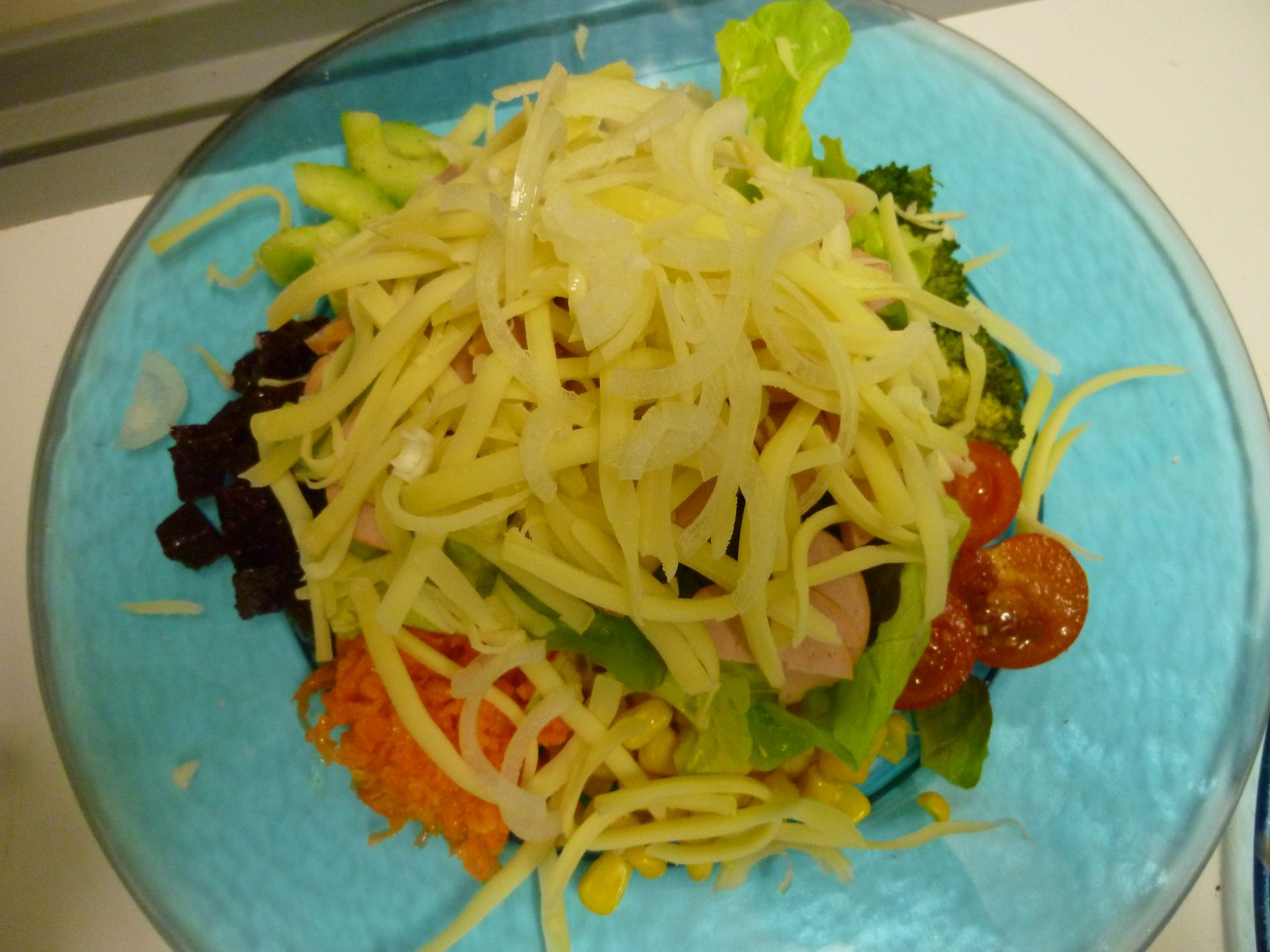 Eine Nahaufnahme von einem Salat auf einem blauen Teller