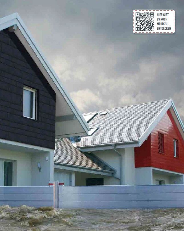 Zwei moderne Häuser in kontrastierenden Farben: Schwarz und Rot, unter einem bewölkten Himmel.