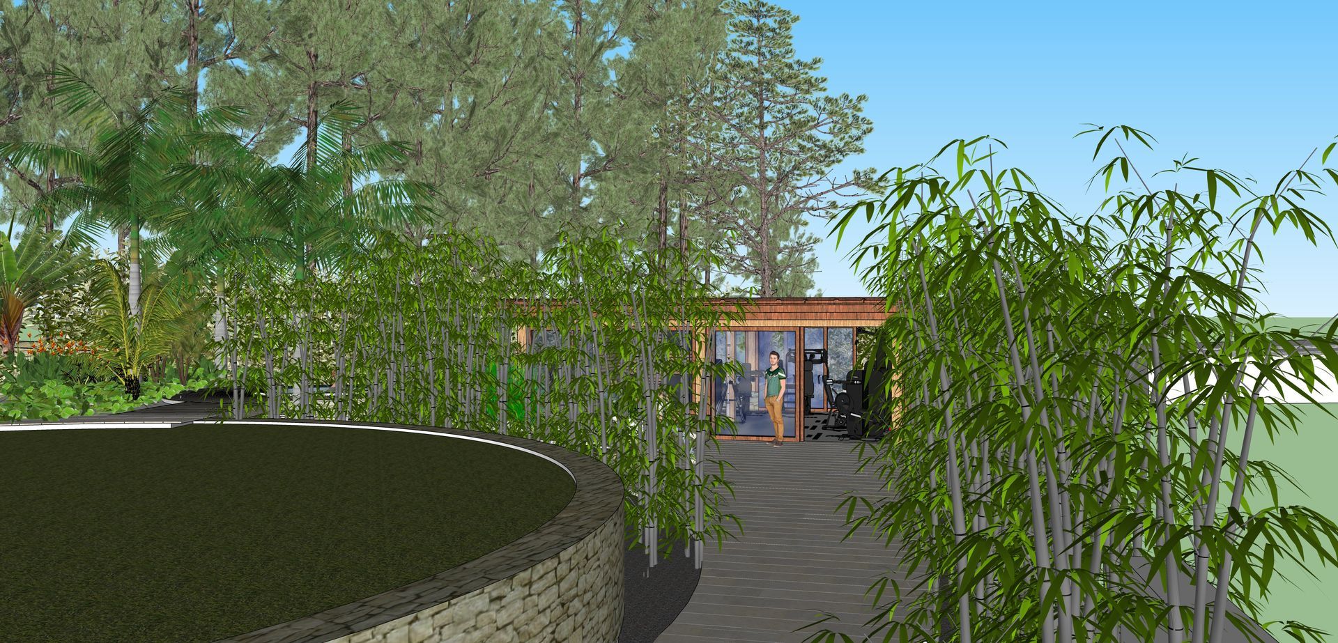 Camino a través de bambú hacia un edificio con una fuente de agua a la izquierda y árboles al fondo.