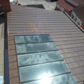 Techo de cobre con tragaluz que refleja la luz del sol.