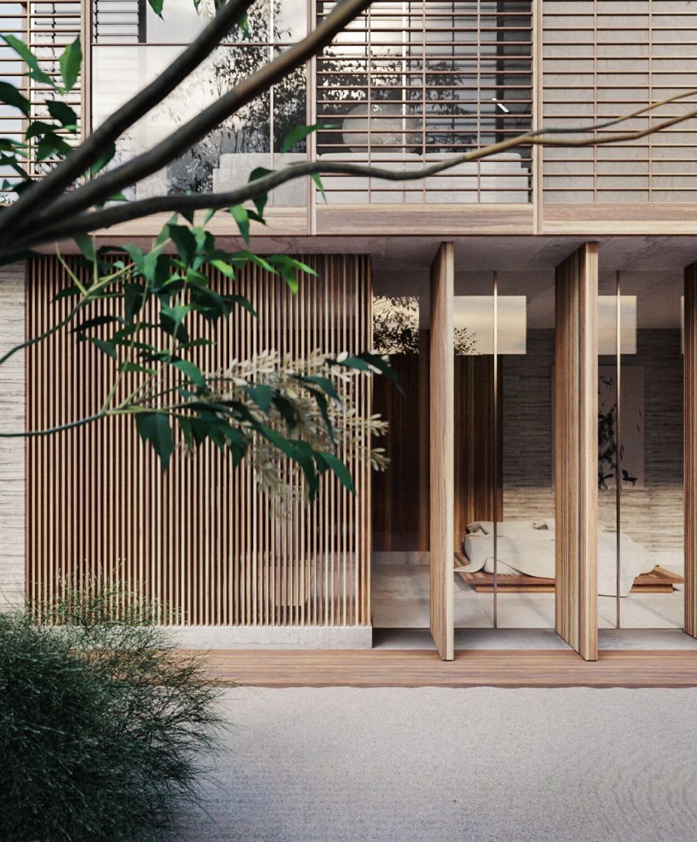 Exterior de un edificio moderno con listones de madera, muros de piedra y vegetación en un entorno natural y sereno.