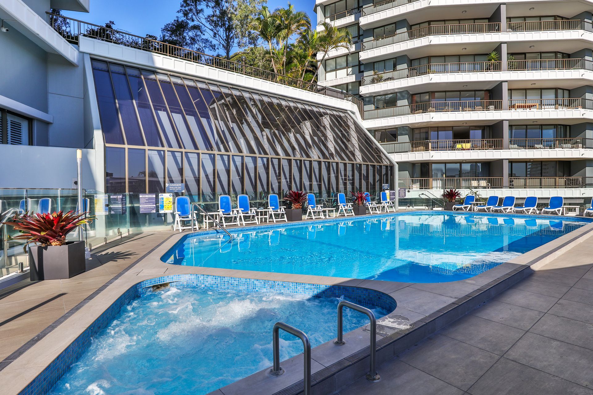 A large swimming pool in front of a building