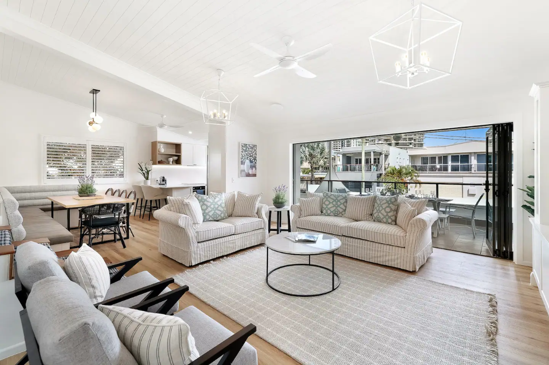 A living room filled with furniture and a ceiling fan.