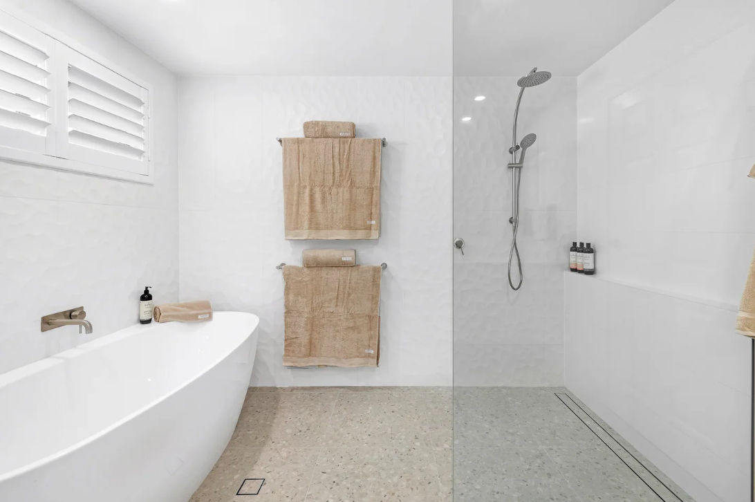 A bathroom with a bathtub and a walk in shower.