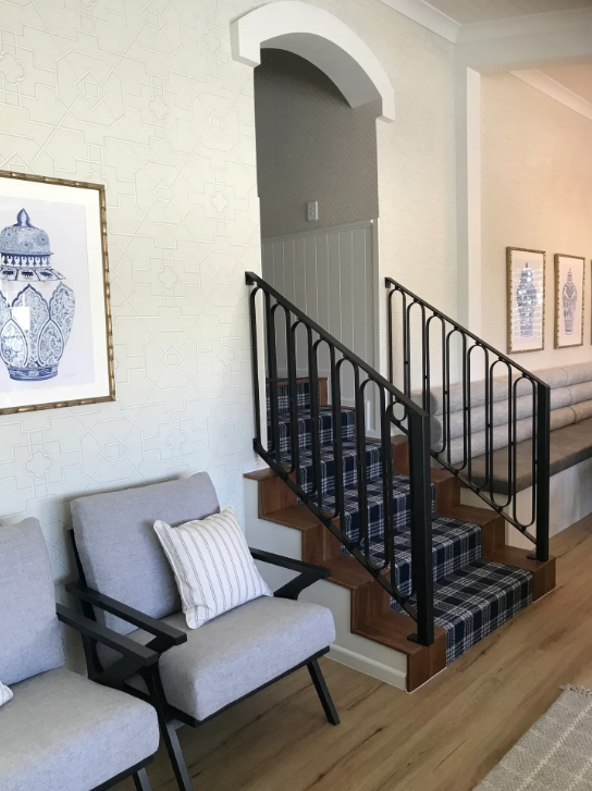 A living room with stairs leading up to the second floor