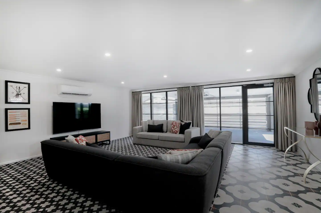 A living room with a couch and a flat screen tv