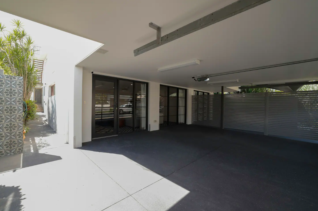 A large empty parking garage with a sliding glass door.