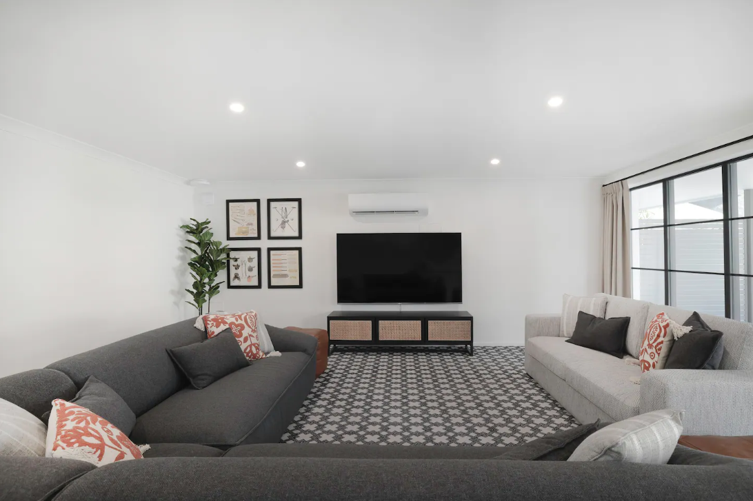 A living room with two couches and a flat screen tv.