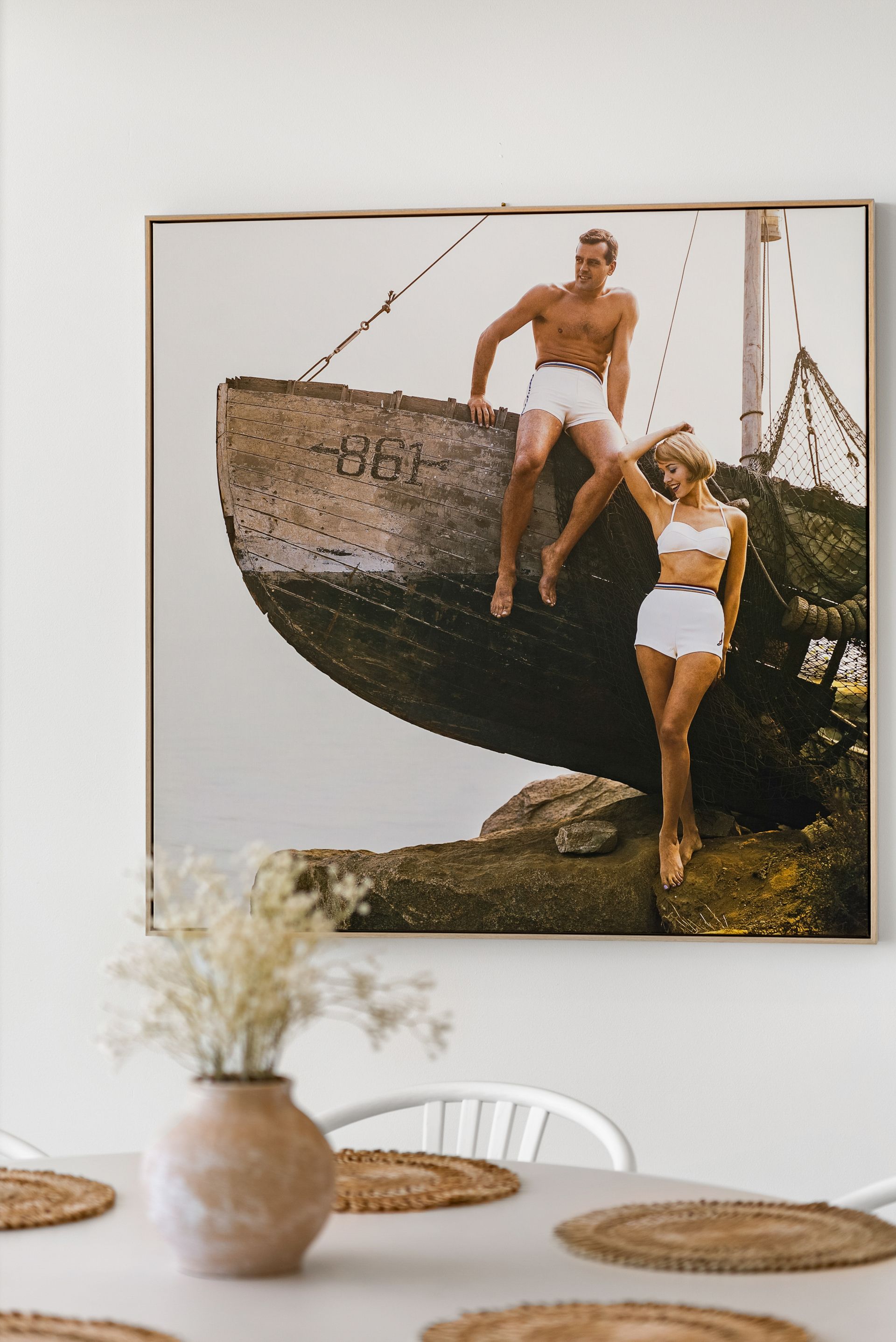 A painting of a man and a woman sitting on a boat