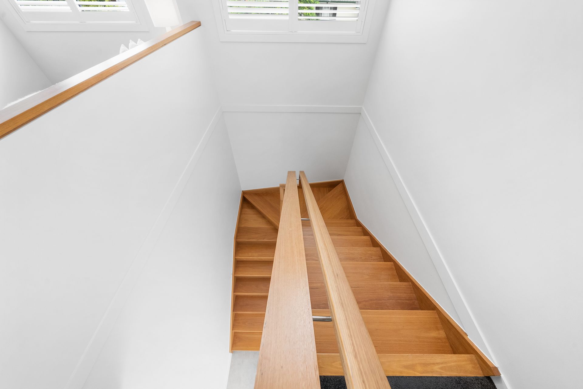 A wooden staircase leading up to the second floor of a house.