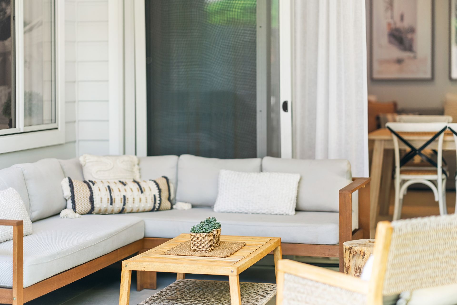 A living room with a couch , chairs , and a table.
