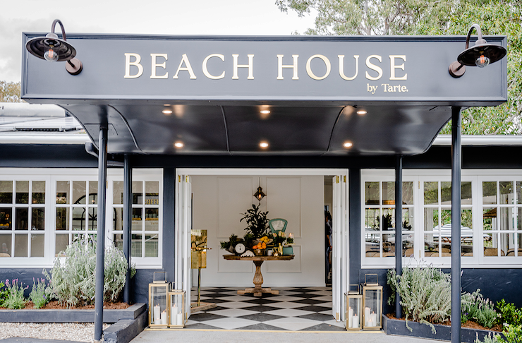 A black and white building with a sign that says beach house