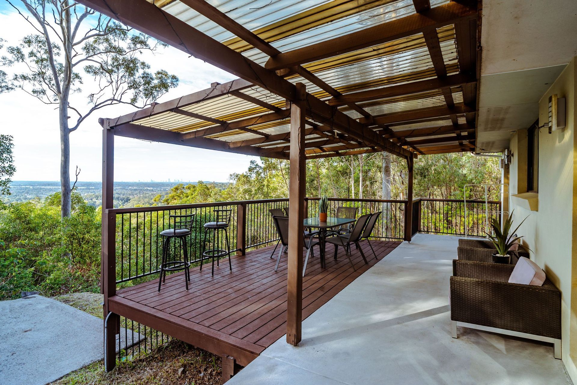 A large wooden deck with a pergola over it