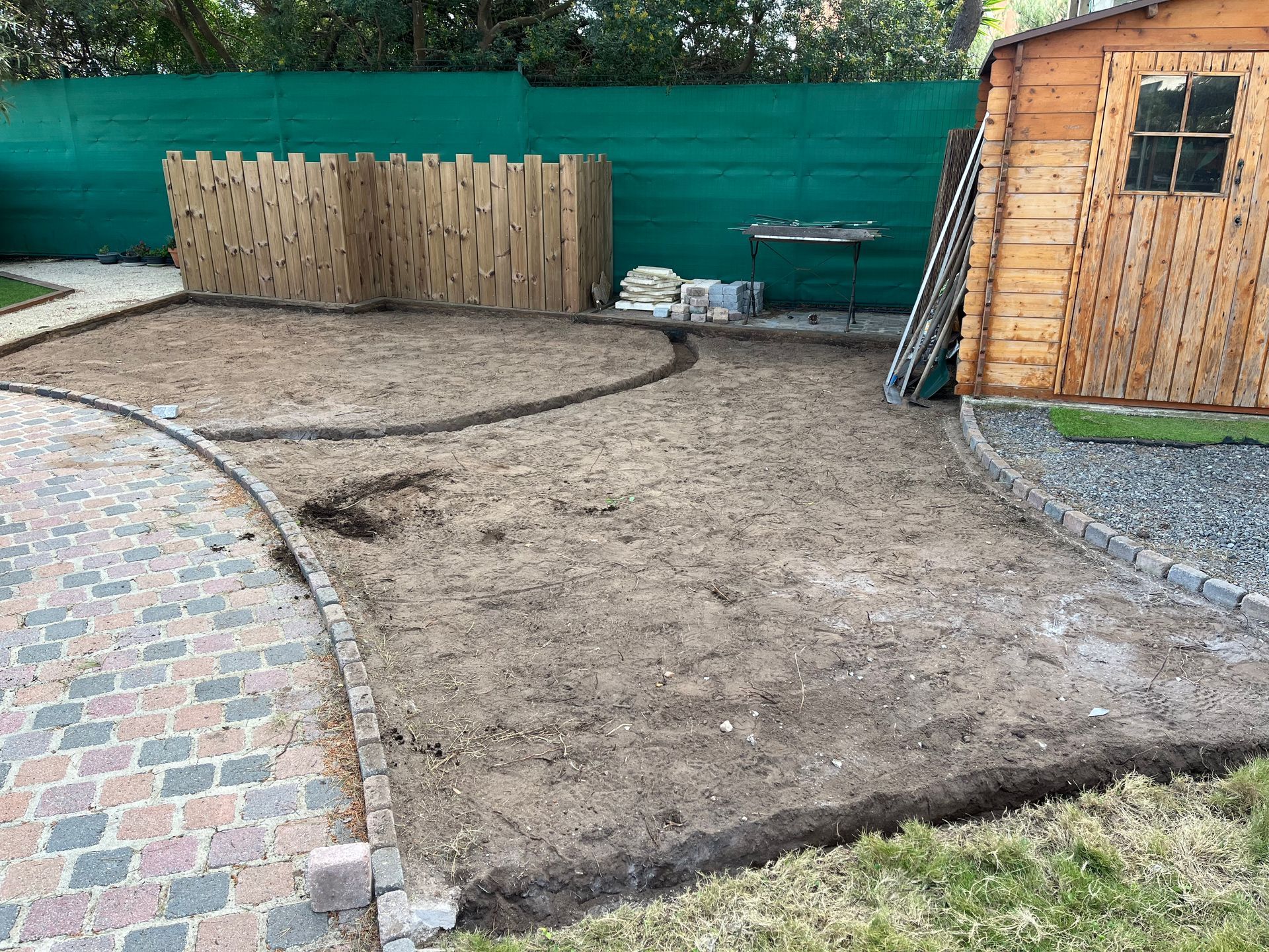 Délimitation d'un motif en cours sur le sol d'une allée