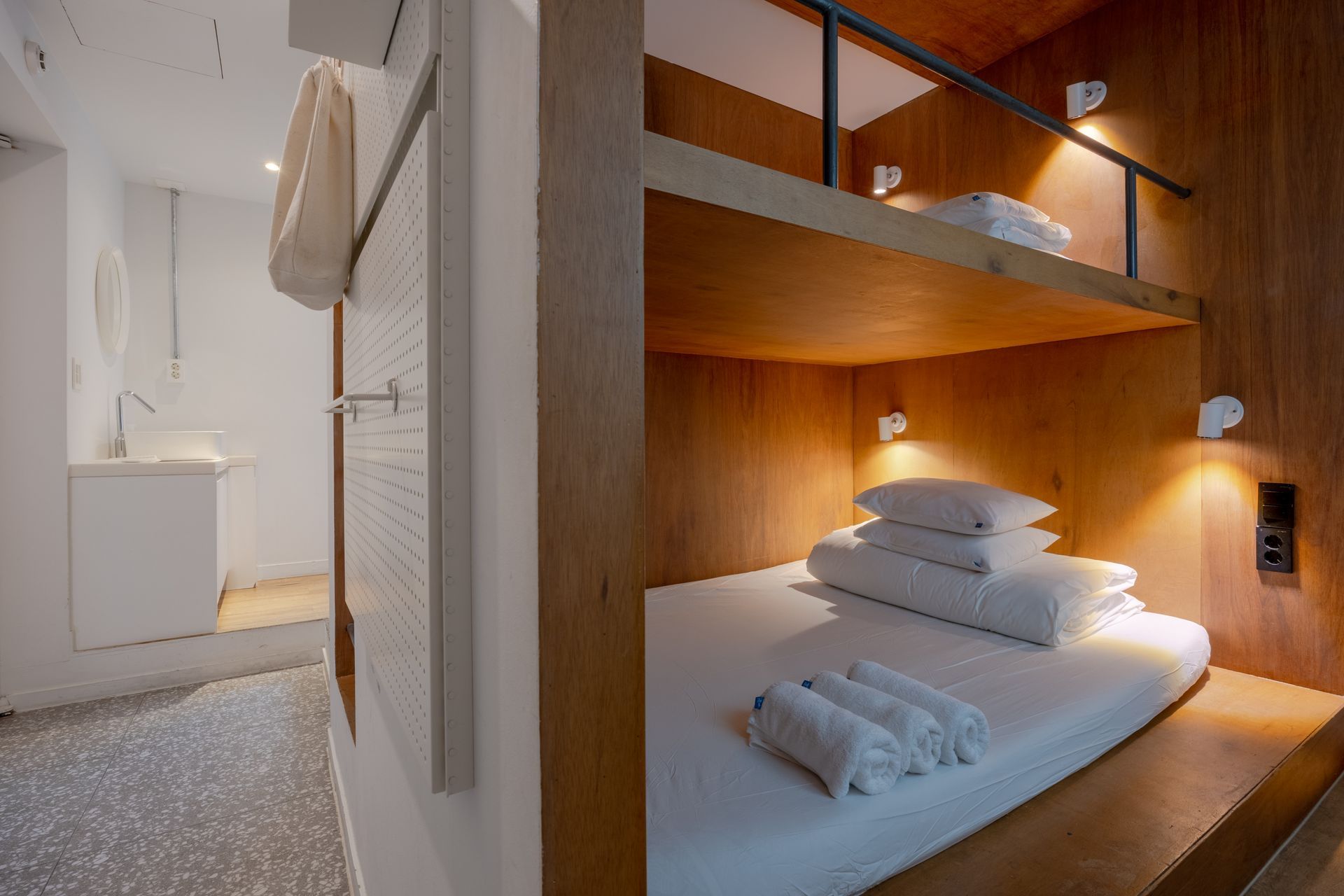A bunk bed with a double bed on lower level, single bed on upper level. Private room with attached bathroom and essential amenities provided. Triple Room - PIPE Hostel Yeonnam