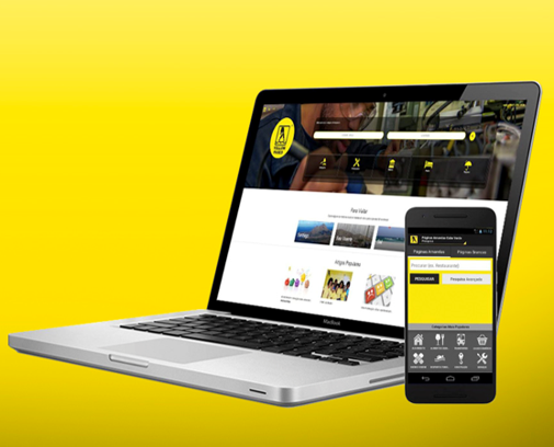 Um laptop e um celular em um fundo amarelo