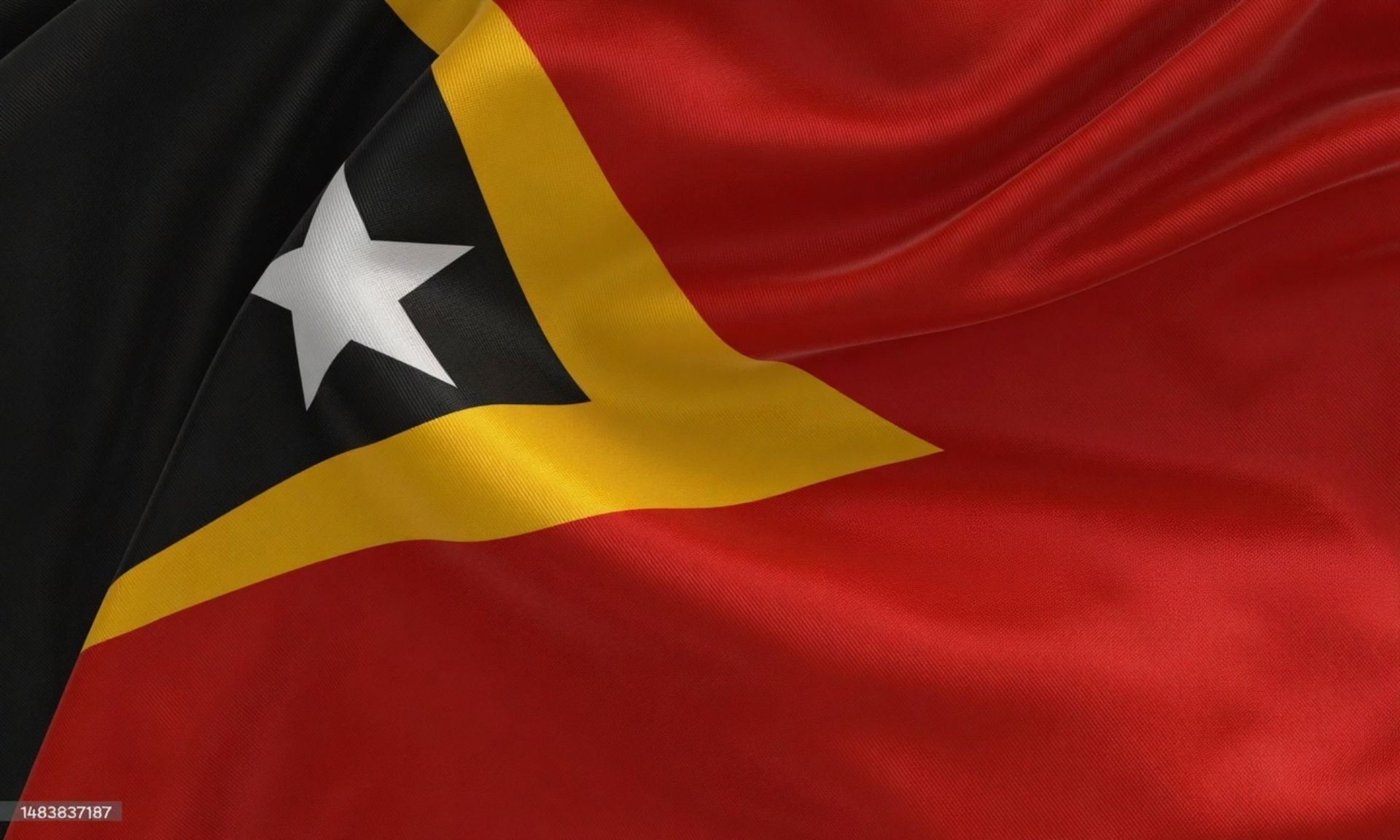 Uma bandeira vermelha, preta e amarela com uma estrela branca