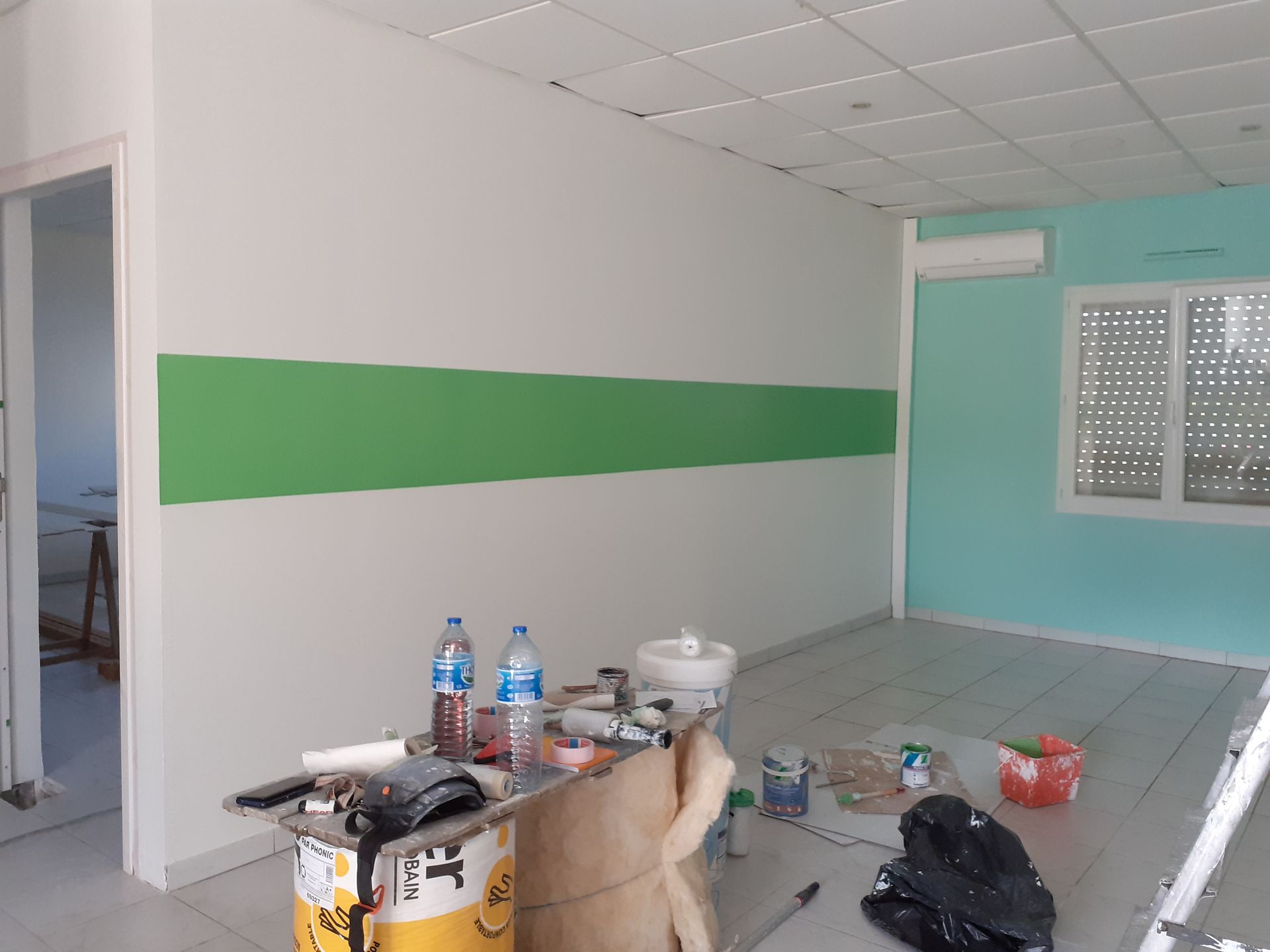 Mur peint en blanc avec une bande verte horizontale