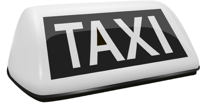 Panneau blanc sur le toit d'un taxi avec l'inscription TAXI en lettres blanches sur fond noir.