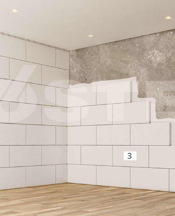 Pared de azulejos blancos con una pared de hormigón parcialmente expuesta en la esquina de una habitación con piso de madera.