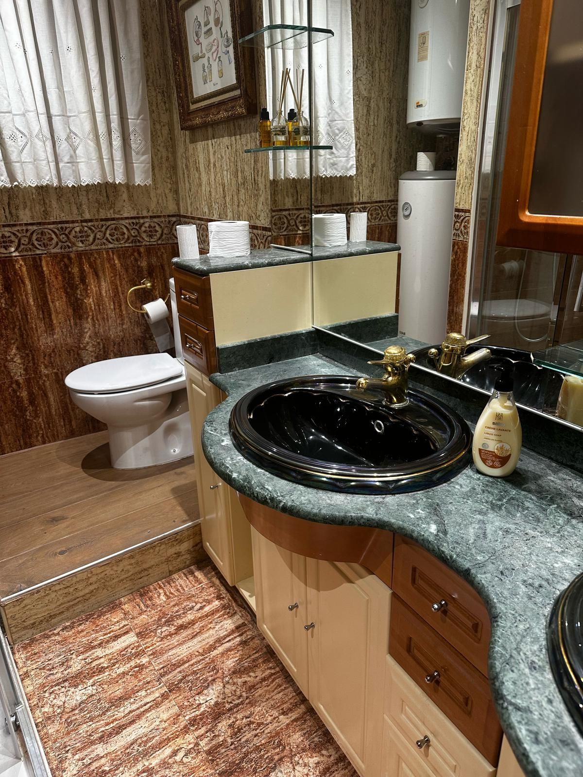 Un baño con inodoro, lavabo y espejo.