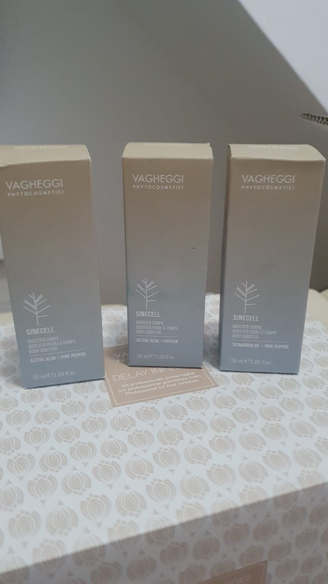 Hay tres cajas de perfume sobre una mesa.
