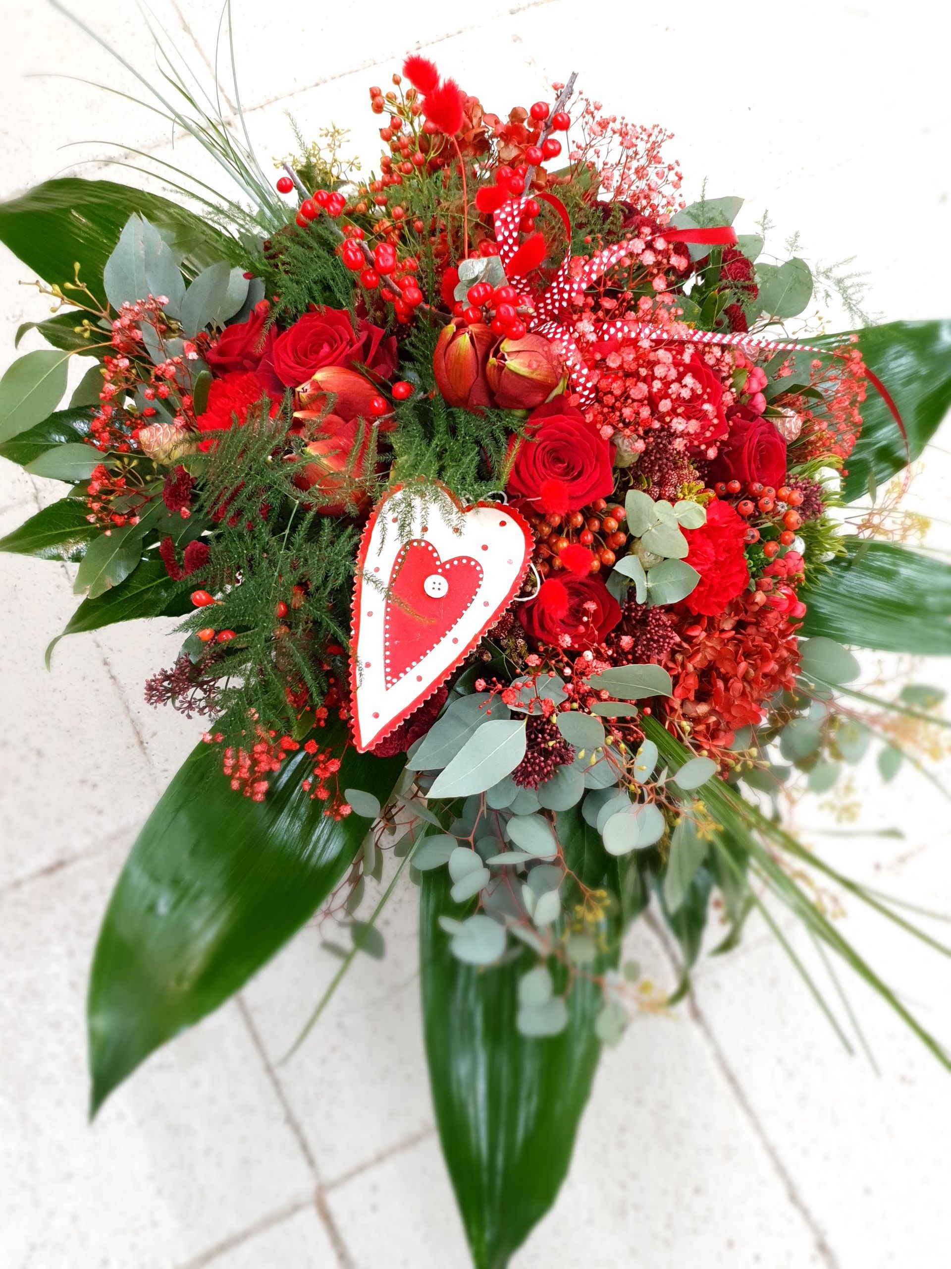 Ein Strauß roter Blumen mit einem Herz darauf