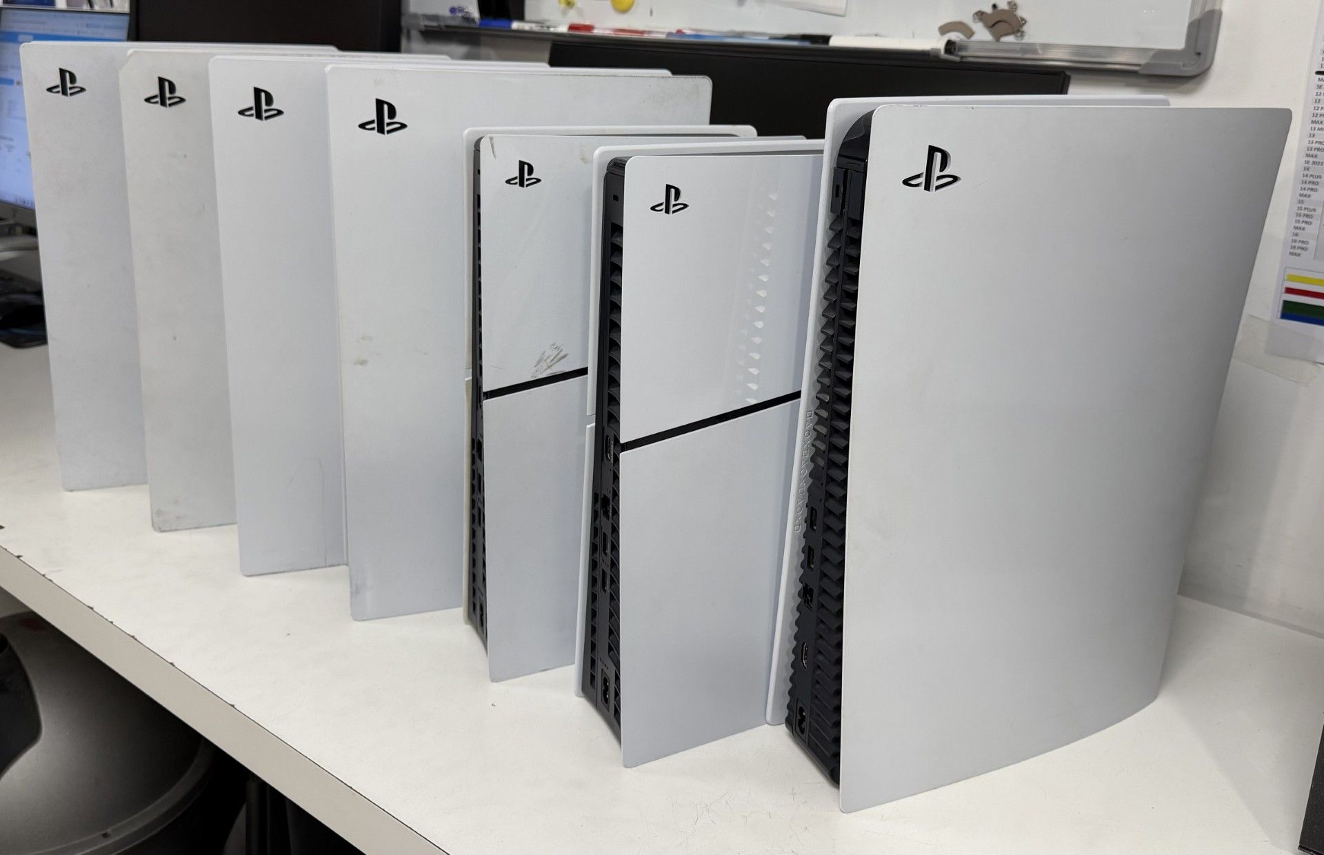 Plusieurs consoles PlayStation 5 blanches disposées en rangée sur une table