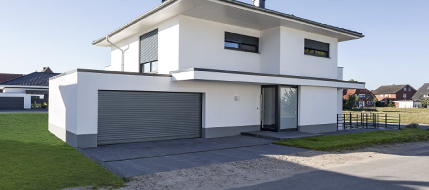 Maison moderne avec une grande porte de garage grise