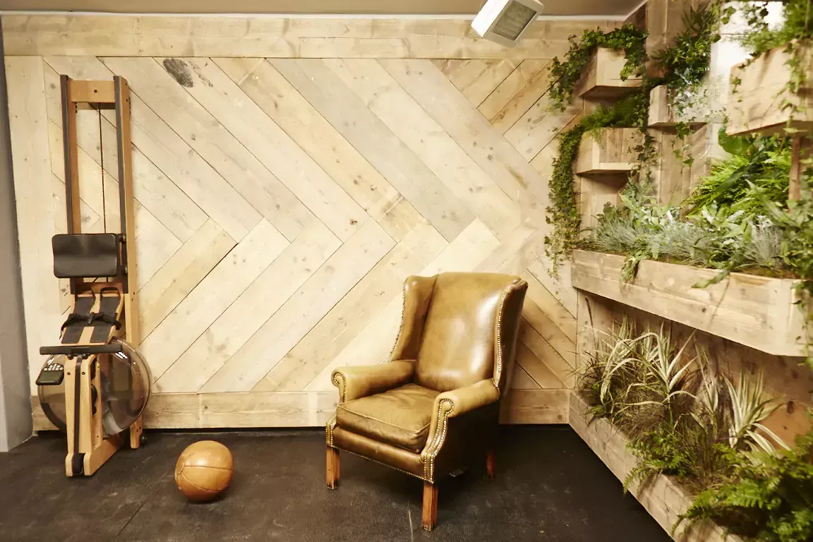 Terra Hale Gym Design: A chair and a ball are in a room with a wooden wall.