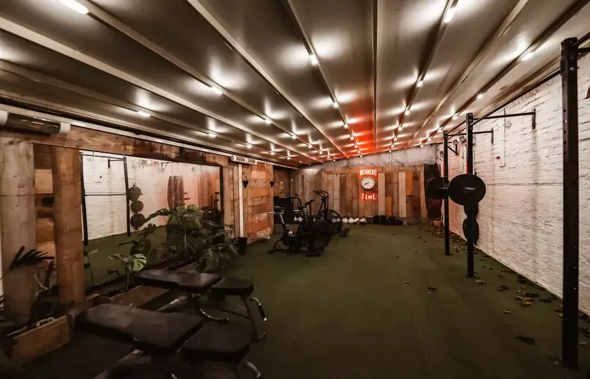 A large room with a lot of exercise equipment in it.