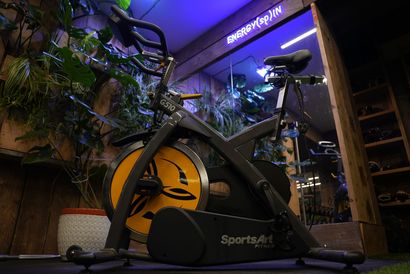 Terra Hale Gym Design: A black and yellow exercise bike is parked in a gym.