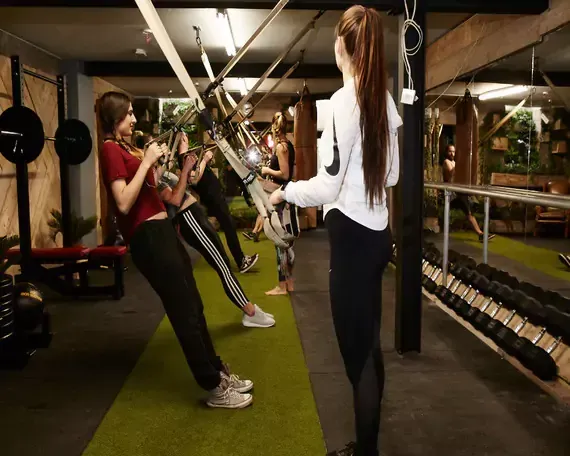 A group of women are doing exercises in a gym.