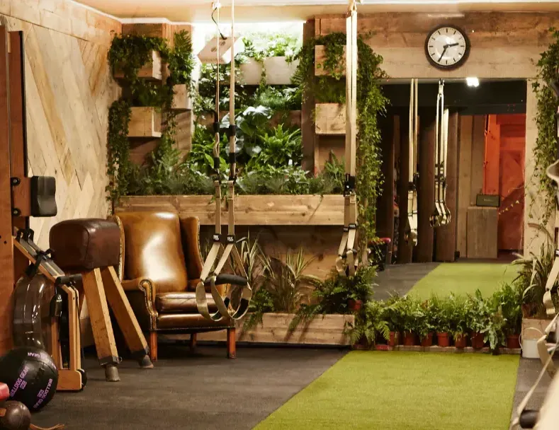 Terra Hale Gym Design: A gym with a chair and a clock on the wall