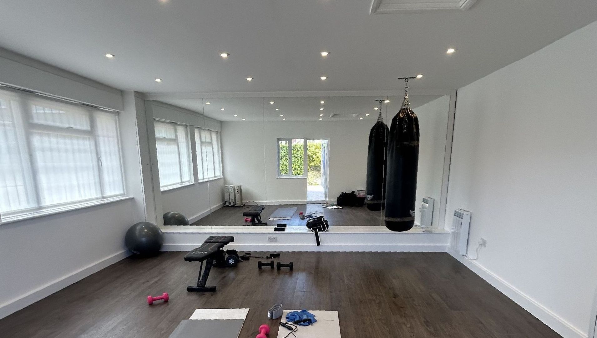 Terra Hale Gym Design: There is a large mirror in the middle of the room.
