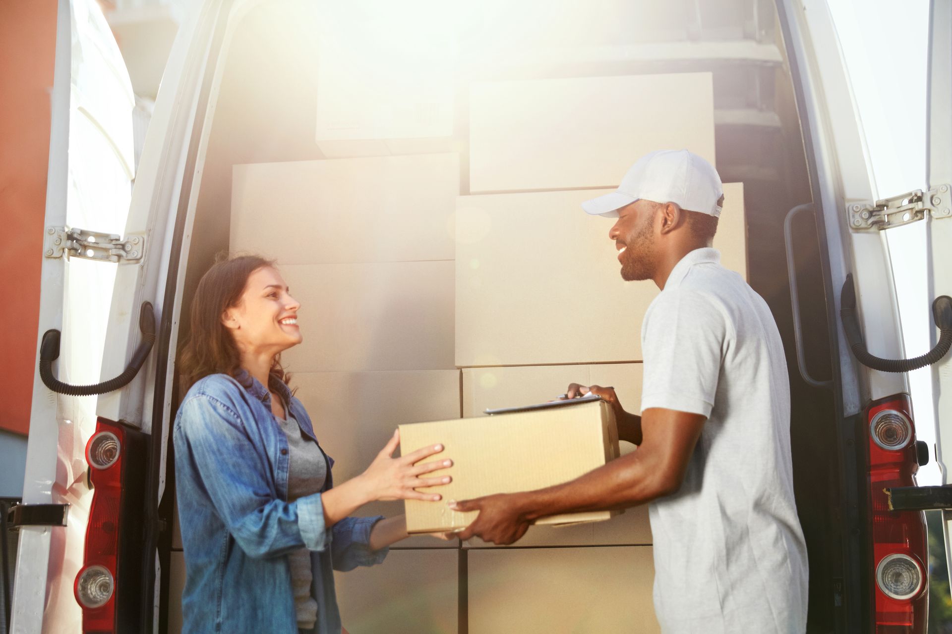 Un livreur donnant un colis à une cliente
