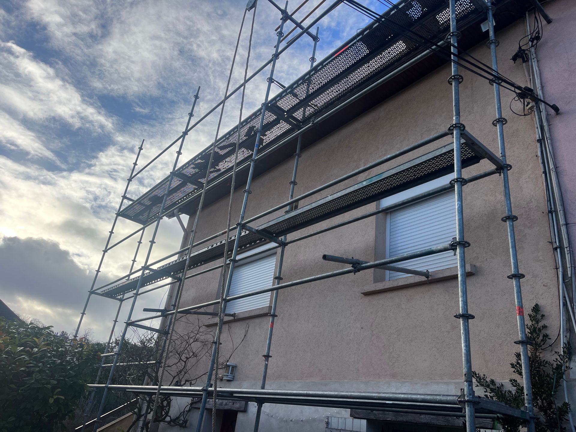 Façade d'une maison avec un échafaudage devant.