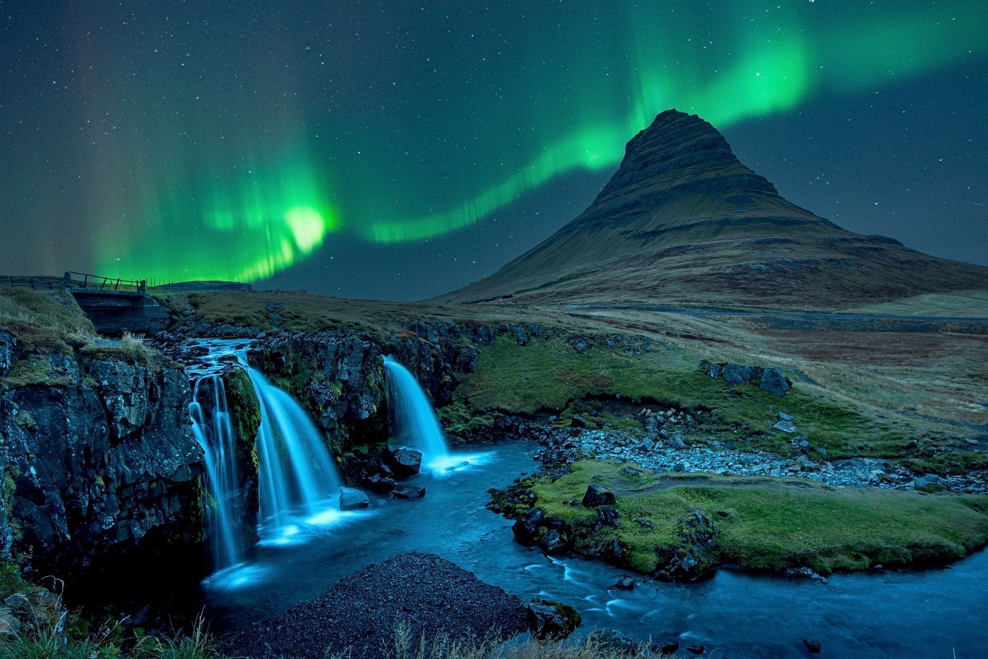 Northern lights over Kirkjufell mountain and waterfalls in Iceland.