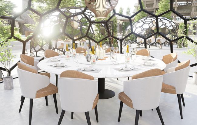 Un comedor con una mesa redonda y sillas.