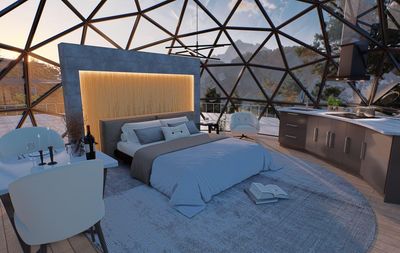 Un dormitorio en forma de cúpula con una cama grande y una cocina.