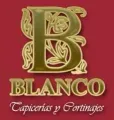 Logotipo para Blanco Tapicerías y Cortinajes, que presenta una "B" ornamentada de color dorado sobre un fondo rojo oscuro.