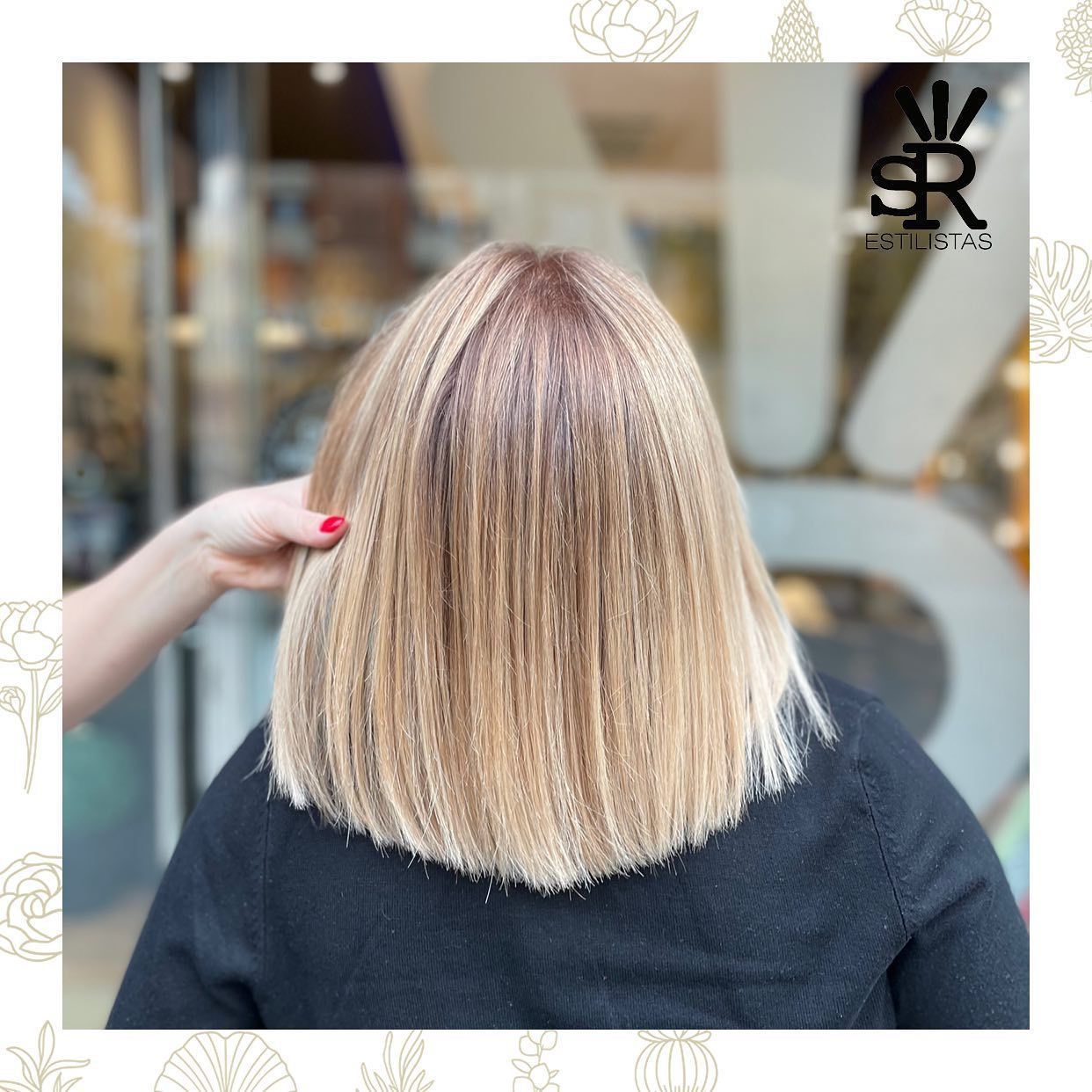 Cabello rubio hasta los hombros con raíces oscuras, peinado con un patrón elegante y rizado.