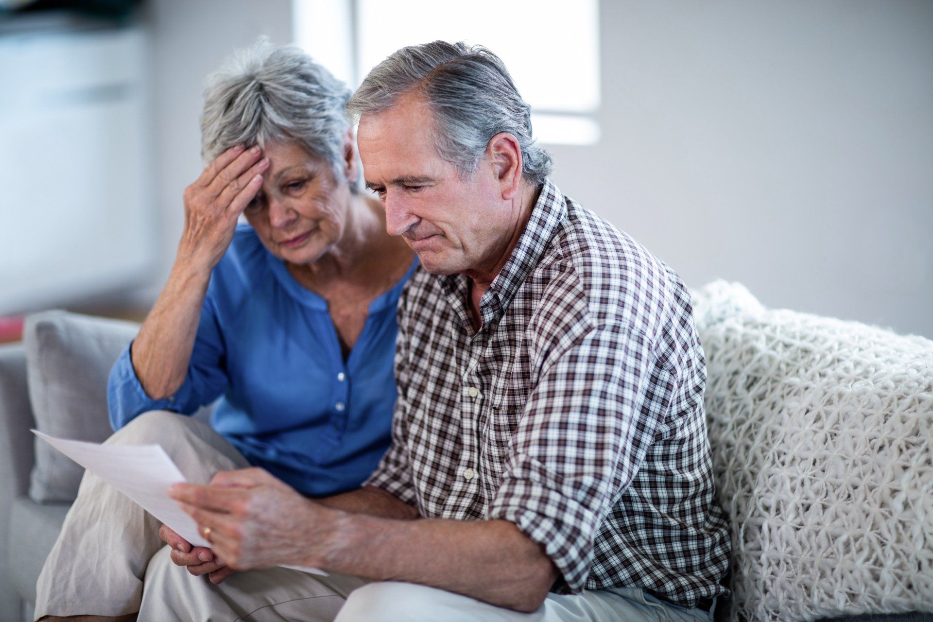 Couple senior inquiet devant un document