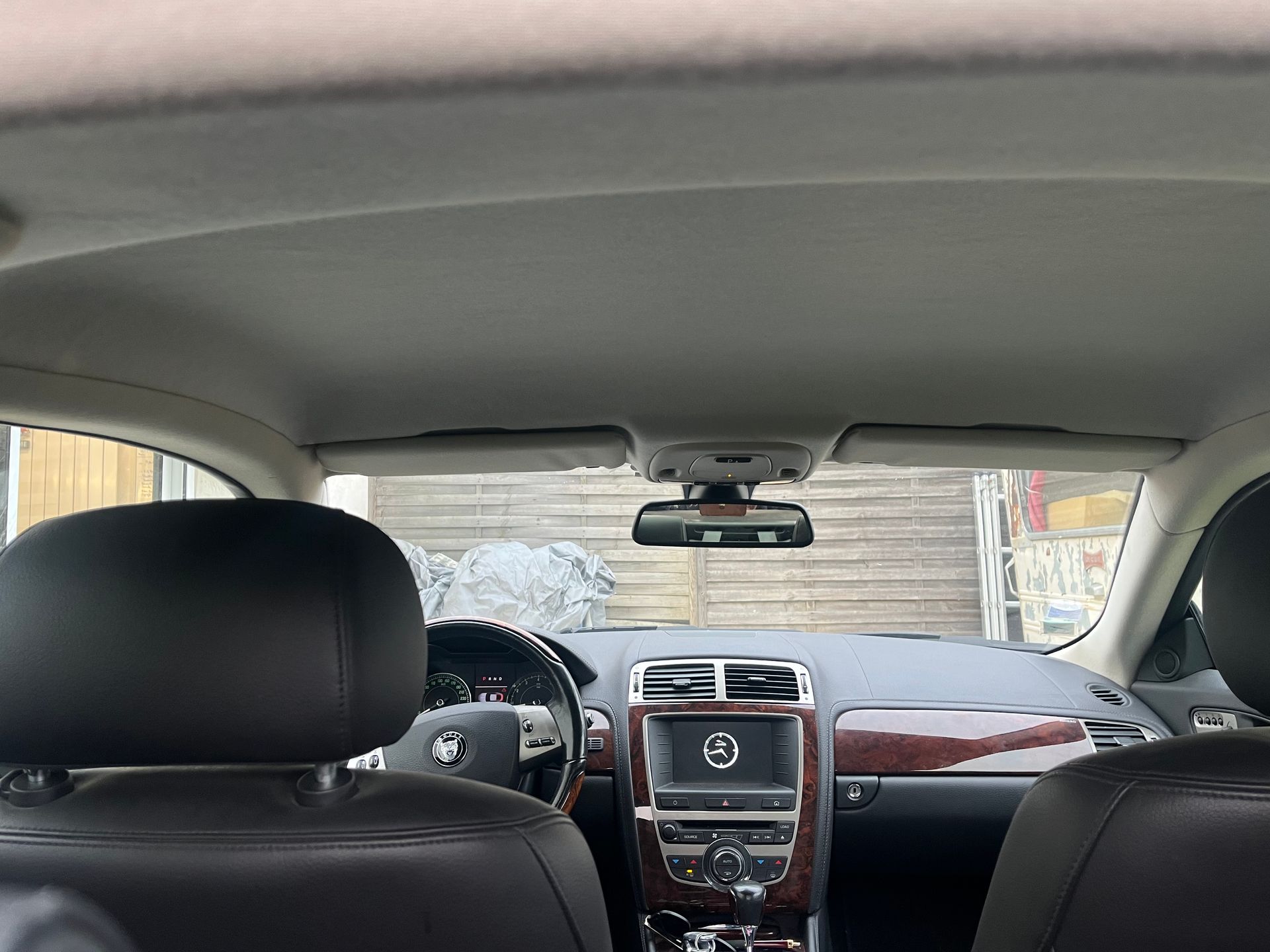 Vue intérieure depuis la banquette arrière d'une voiture, montrant des appuie-tête en cuir.