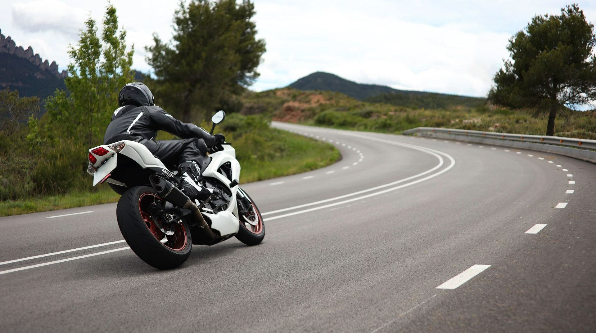 Un motard en train de rouler en moto sur une route