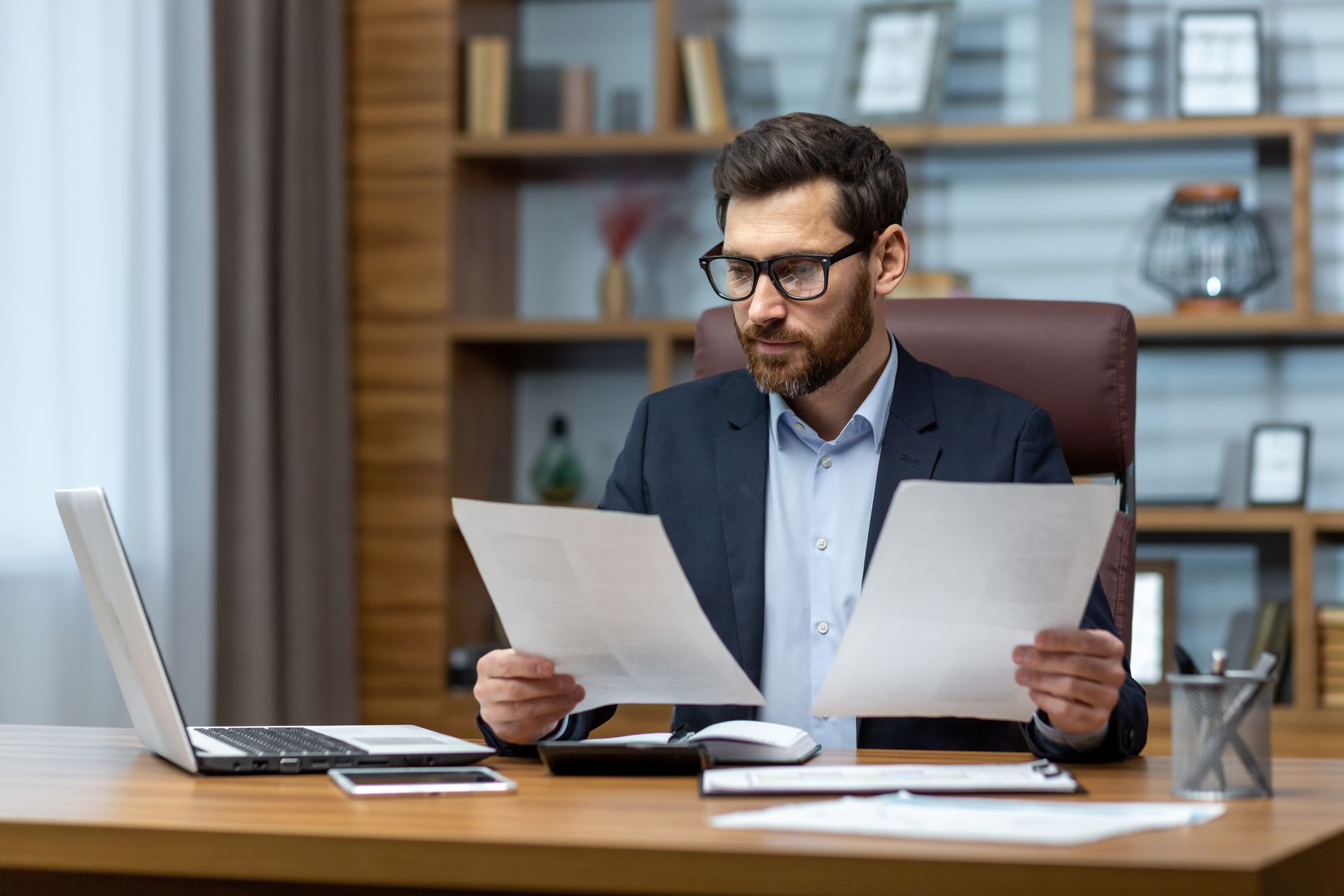 Un homme portant des lunettes étudie des documents