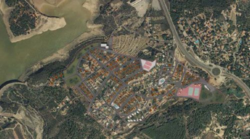 Una vista aérea de una zona residencial con un río al fondo.