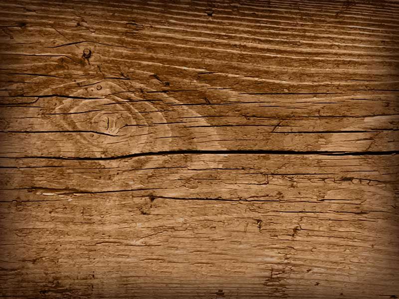 Un primer plano de un trozo de madera con un nudo.